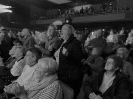 Black and white photo of people sitting in a theatre